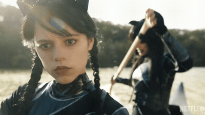 A Girl In A Cat Costume Is Standing Next To Another Girl In A Netflix Advertisement GIF