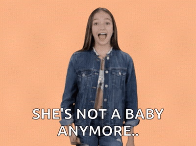 A Girl In A Denim Jacket Giving A Thumbs Down Sign With The Words She 'S Not A Baby Anymore GIF