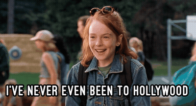 A Girl In A Denim Jacket Is Laughing And Says " I 'Ve Never Even Been To Hollywood " GIF
