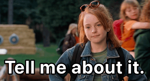 A Girl In A Denim Jacket With The Words Tell Me About It Above Her GIF