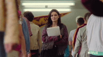 A Girl In A Fringed Jacket Is Standing In A Hallway With Netflix Written On The Bottom GIF