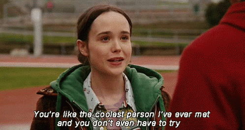 A Girl In A Green Jacket Is Talking To A Man In A Red Jacket . GIF