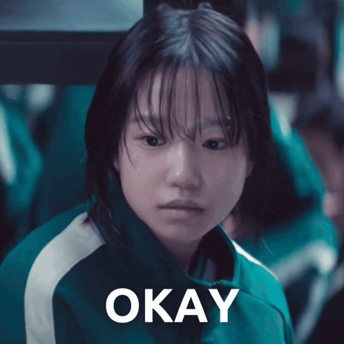 A Girl In A Green Jacket Says Okay GIF