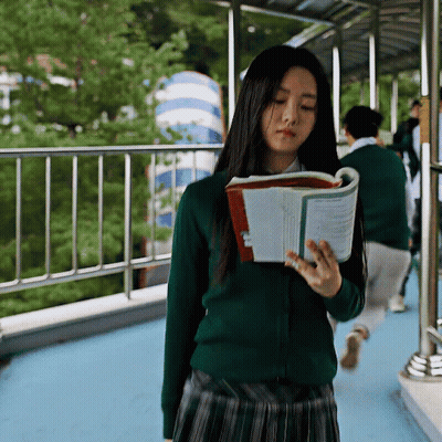 A Girl In A Green Sweater Reads A Book GIF