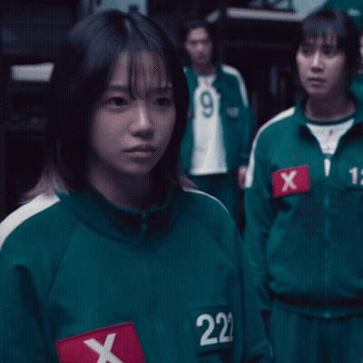A Girl In A Green Uniform With The Number 222 On Her Chest GIF