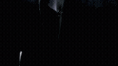 A Girl In A Maid Dress Is Standing In Front Of A Group Of People GIF