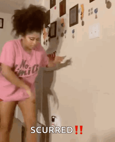 A Girl In A Pink Shirt Is Dancing In A Room With The Words Scurred Written On It GIF