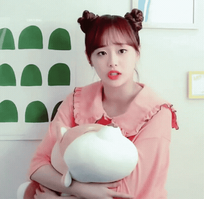 A Girl In A Pink Shirt Is Holding A Stuffed Animal In Her Arms And The Word Chuling Is Above Her GIF