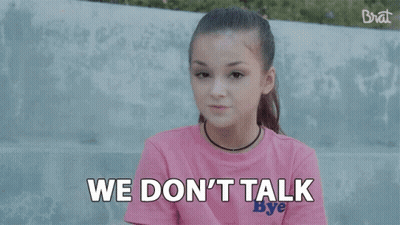 A Girl In A Pink Shirt Is Saying `` We Make Money Moves '' While Sitting On A Bench . GIF