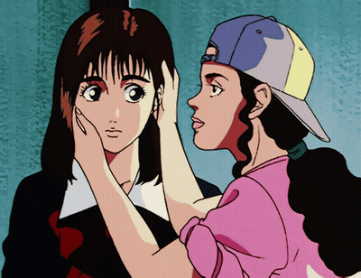 A Girl In A Pink Shirt Is Touching The Face Of Another Girl GIF