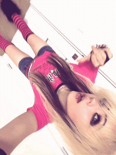 A Girl In A Pink Shirt With The Number 10 On It Is Laying On The Floor GIF