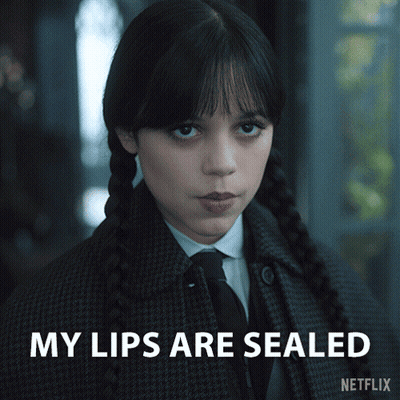 A Girl In A Plaid Coat And Tie With The Words My Lips Are Sealed On The Bottom GIF