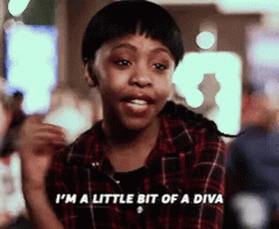 A Girl In A Plaid Shirt Is Saying " I 'M A Little Bit Of A Diva " GIF