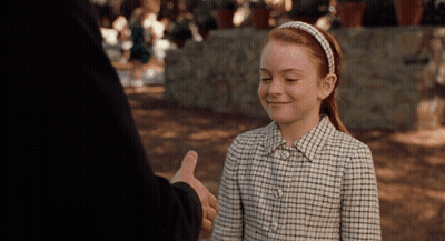A Girl In A Plaid Shirt Smiles While Giving A Thumbs Up GIF