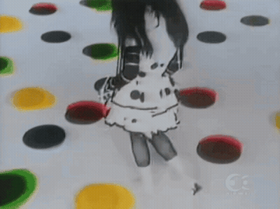 A Girl In A Polka Dot Dress Is Playing A Game With Colorful Circles GIF