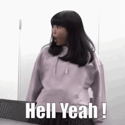A Girl In A Purple Sweatshirt Is Standing In Front Of A Wall And Saying `` Hell Yeah ! '' GIF