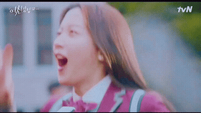 A Girl In A Purple Uniform Is Giving A High Five To Someone . GIF