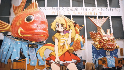 A Girl In A Red Dress Is Standing In Front Of A Large Fish Statue GIF