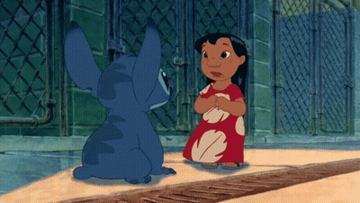 A Girl In A Red Dress Is Standing Next To A Blue Cartoon Character GIF