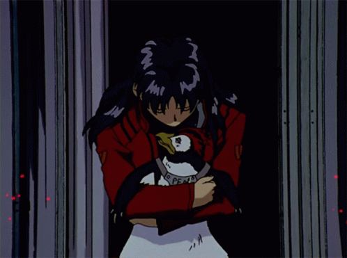 A Girl In A Red Jacket Is Holding A Penguin With A Necklace That Says Peace GIF