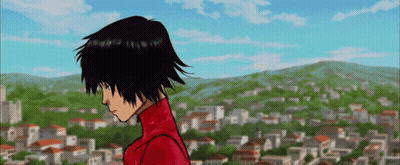 A Girl In A Red Jacket Stands In Front Of A Town GIF