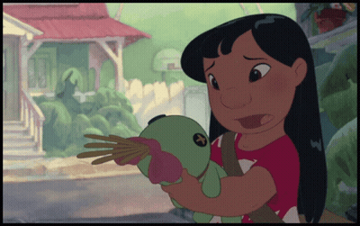A Girl In A Red Shirt Is Holding A Stuffed Animal GIF