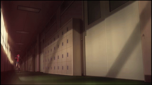 A Girl In A Red Shirt Is Walking Down A Hallway GIF