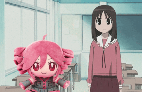 A Girl In A Red Skirt Stands Next To A Stuffed Doll With A Pink Hair GIF
