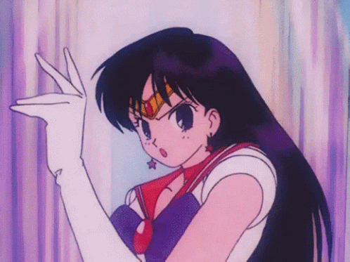A Girl In A Sailor Moon Outfit Is Making A Peace Sign GIF