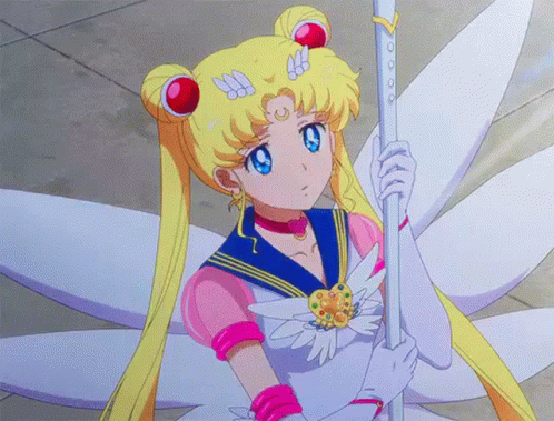 A Girl In A Sailor Suit Is Holding A Wand In Her Hand . GIF