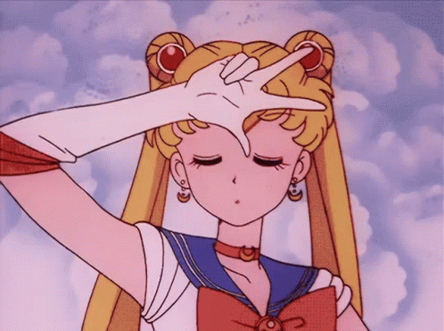 A Girl In A Sailor Suit Is Making A Peace Sign With Her Finger GIF