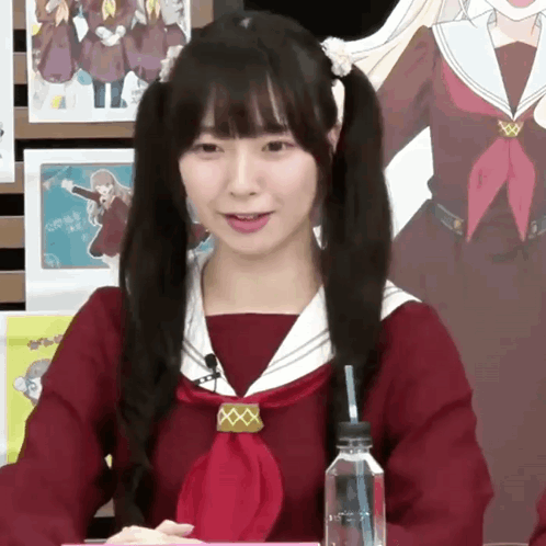 A Girl In A School Uniform Holds A Straw In Her Hand GIF
