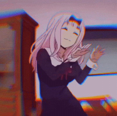 A Girl In A School Uniform Is Dancing In A Room With A Blurry Background . GIF