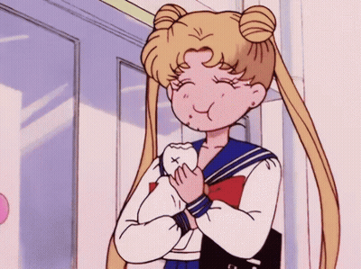 A Girl In A School Uniform Is Holding A Tooth In Her Hands . GIF