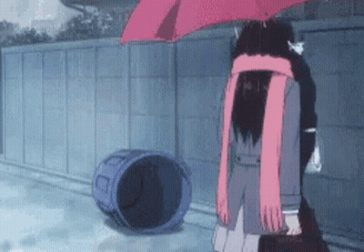 A Girl In A School Uniform Is Holding An Umbrella In The Rain While Standing Next To A Trash Can . GIF