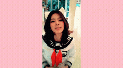 A Girl In A School Uniform Is Making A Funny Face With Her Hands GIF