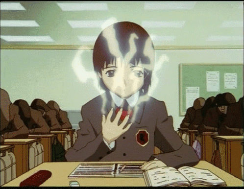 A Girl In A School Uniform Is Sitting At A Desk With A Book In Front Of Her GIF
