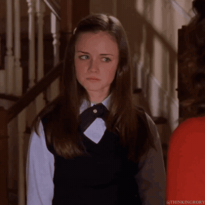 A Girl In A School Uniform Is Standing Next To A Woman In A Red Shirt GIF