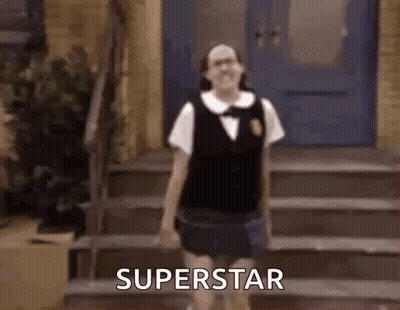 A Girl In A School Uniform Is Standing On A Set Of Stairs And Says Superstar . GIF