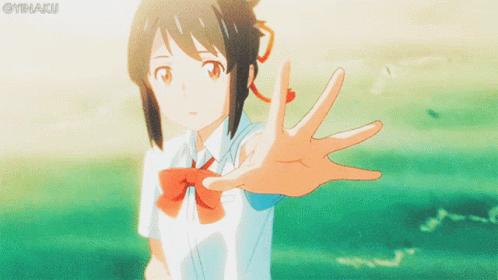 A Girl In A School Uniform Reaches Out Her Hand Towards The Camera GIF