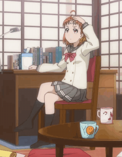 A Girl In A School Uniform Sits In A Chair With Her Hand On Her Head GIF