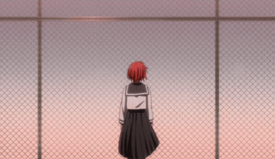 A Girl In A School Uniform Stands Behind A Chain Link Fence GIF