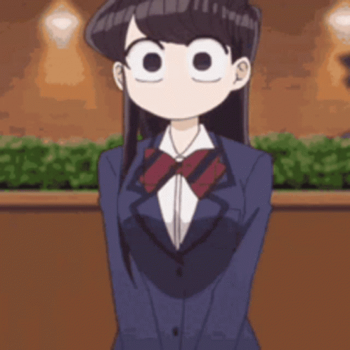 A Girl In A Suit And Bow Tie Is Standing In Front Of A Building . GIF