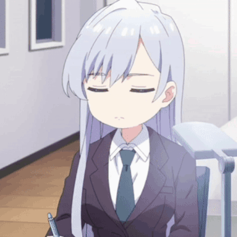 A Girl In A Suit And Tie Is Sitting At A Desk With Her Eyes Closed GIF