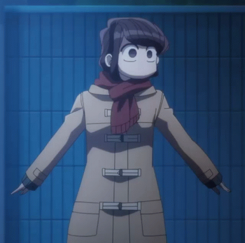 A Girl In A Trench Coat And Scarf Stands In Front Of A Blue Tiled Wall GIF