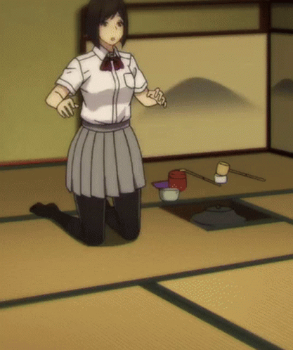 A Girl In A White Shirt And Grey Skirt Is Kneeling On The Floor GIF