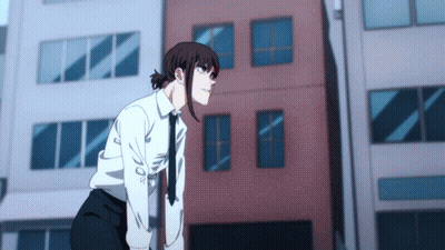 A Girl In A White Shirt And Tie Is Standing In Front Of A Building GIF