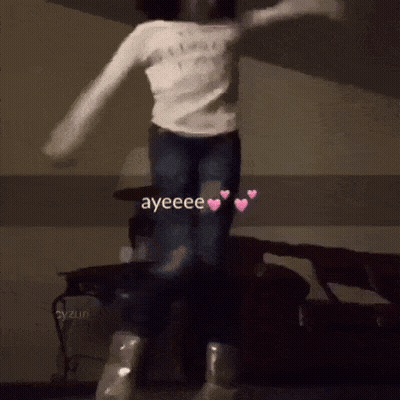 A Girl In A White Shirt Is Jumping In The Air With The Words Ayeeee Written On The Bottom GIF