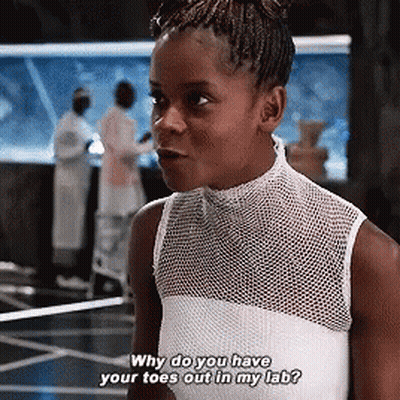 A Girl In A White Tank Top Is Asking Why Do You Have Your Toes Out In My Lab GIF