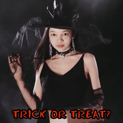 A Girl In A Witch Costume Is Holding A Flashlight And The Words Trick Or Treat Are Below Her GIF